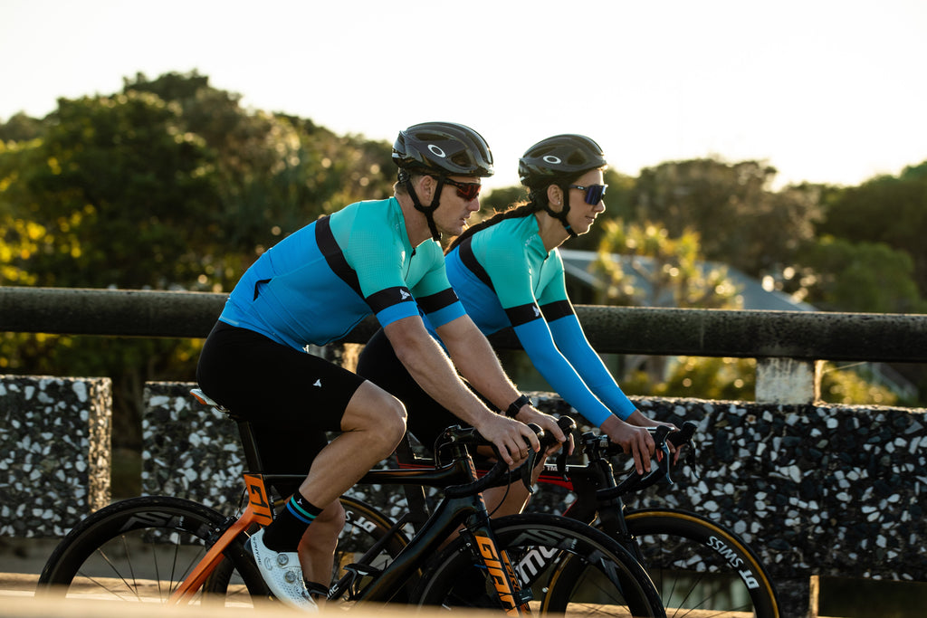 cyclists wearing the mens and womens cycling jersey SYKL PRO