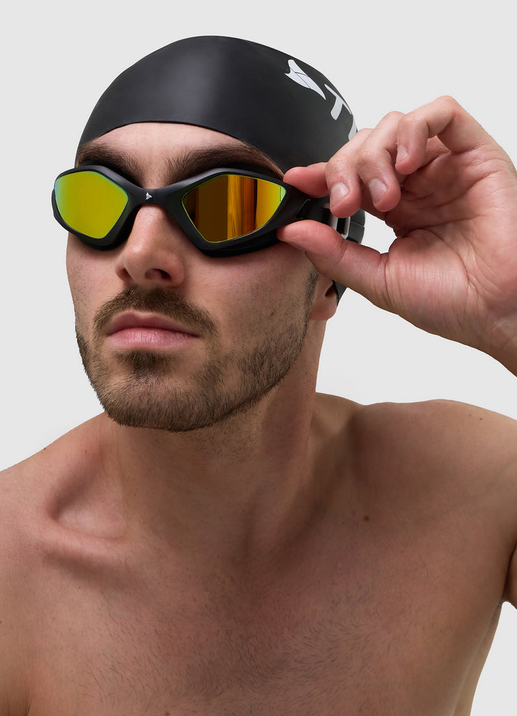 Male swimmer wearing TRI-FIT RAPID-X swim goggles in black