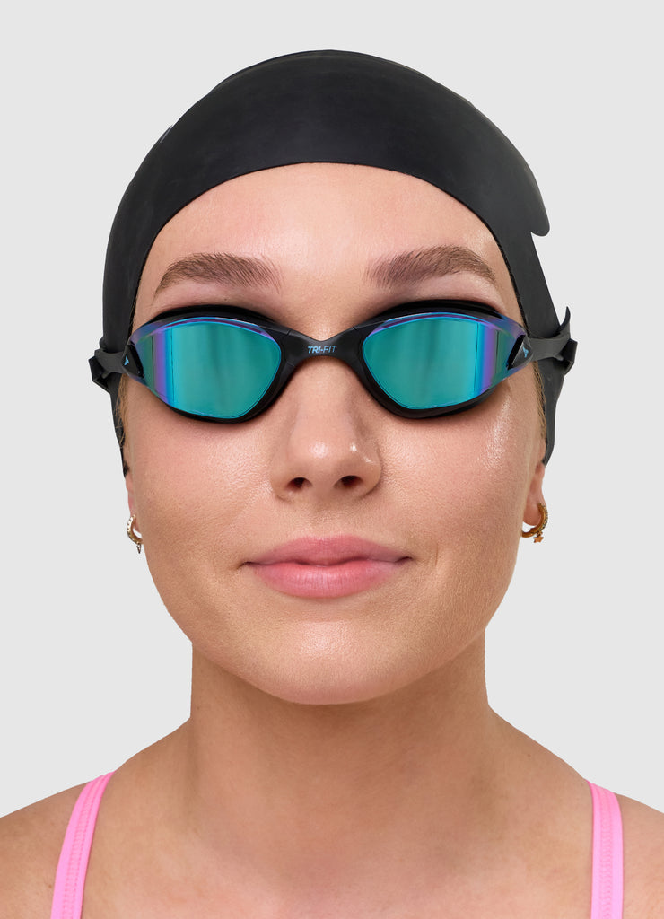 Female swimmer wearing TRI-FIT PROPEL swim goggles in white