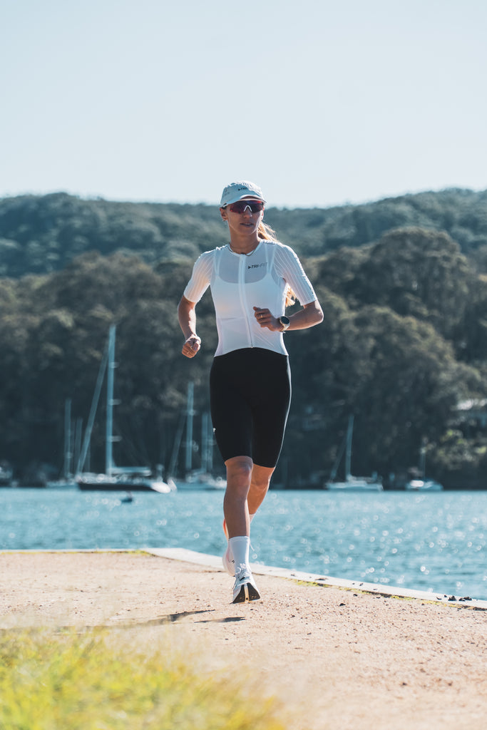 Women running in a TRI-FIT VORTEX tri-suit 