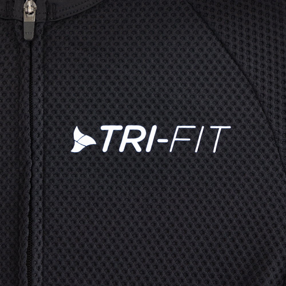 Close-up of TRI-FIT logo printed on chest of men’s VANGUARD tri-suit in black, with breathable textured mesh fabric