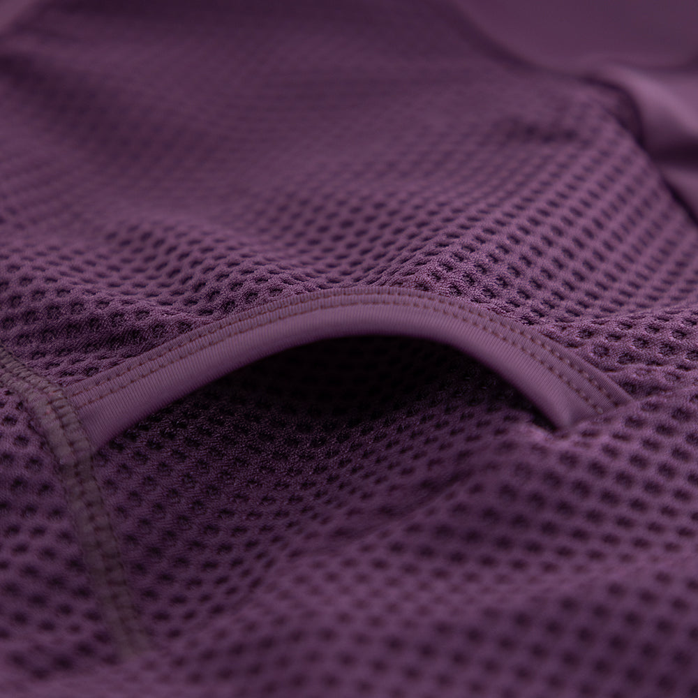 Close-up of rear pocket opening and internal stitching on VANGUARD tri-suit in plum