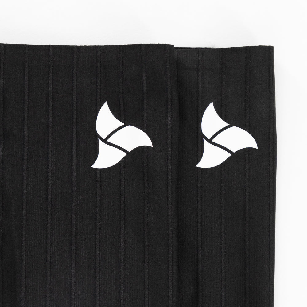 Front logo view of VORTEX Calf Sleeves with ribbed texture designed to disrupt airflow and reduce drag.