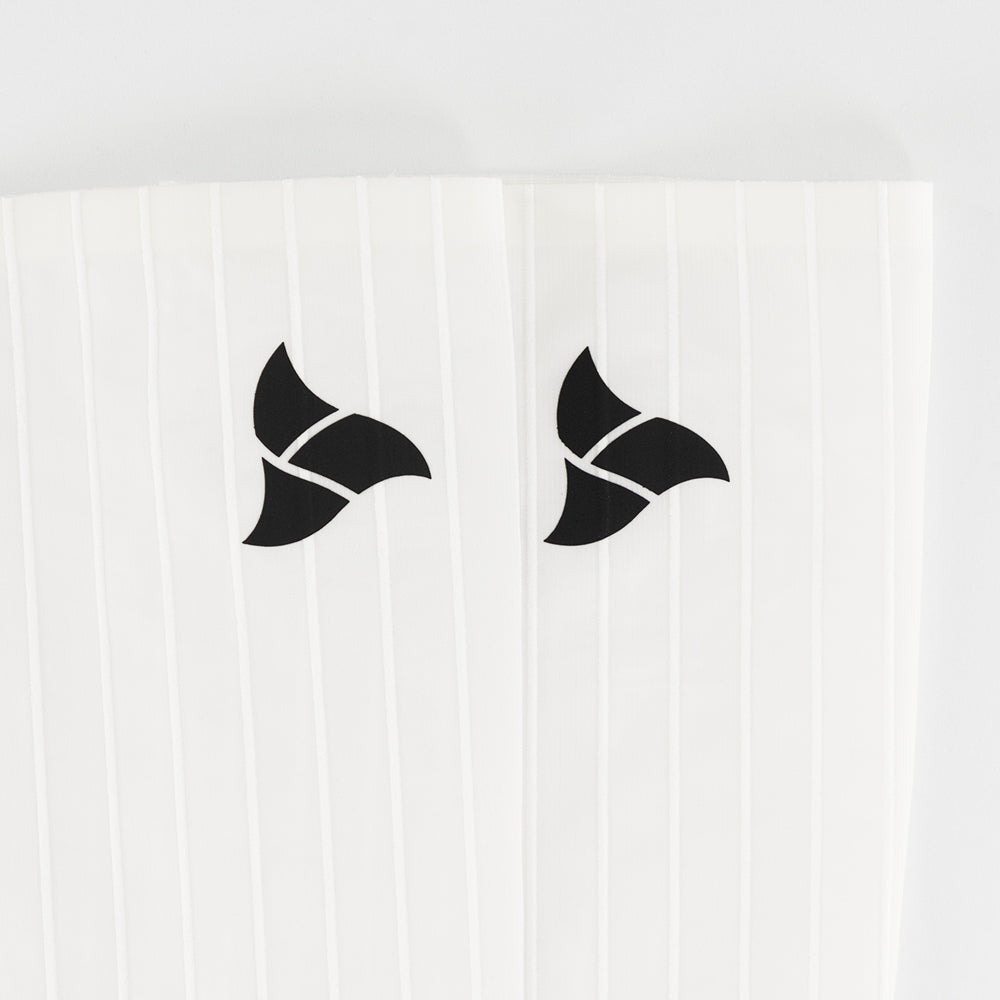 Front logo view of VORTEX Calf Sleeves with ribbed texture designed to disrupt airflow and reduce drag.