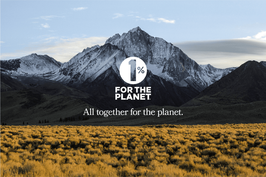 Picture of field with mountains in the background with 1% For The Planet logo in white overlay, texting saying 'all together for the planet'