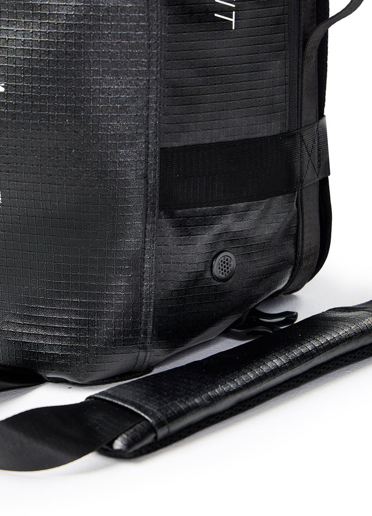 Close-up of lower corner showing webbing, strap, and mesh ventilation